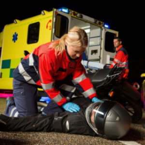 Should the crash helmet be removed from a motorcycle passenger who has